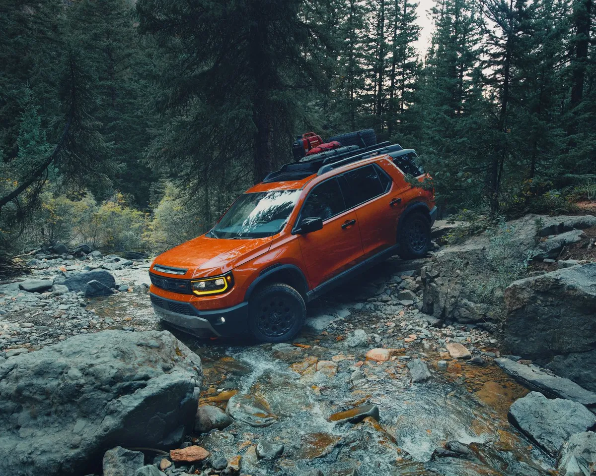 Side profile shot of the 2026 Honda Passport parked on rocks.